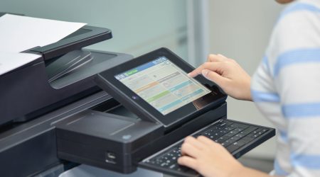 Business Woman Using Cloud-Based App on Photocopier