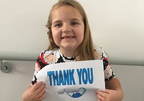 Little Girl from The Ark Centre Charity Holding Thank You Sign